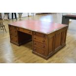 A late 19th/early 20th century mahogany partner's desk,
