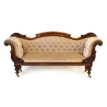 A Victorian walnut and button upholstered sofa on turned legs, l.