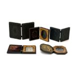 A group of five Victorian daguerreotypes, each housed in an embossed case depicting floral motifs,