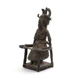 An early 20th century Benin bronze figure modelled as an oba, h.