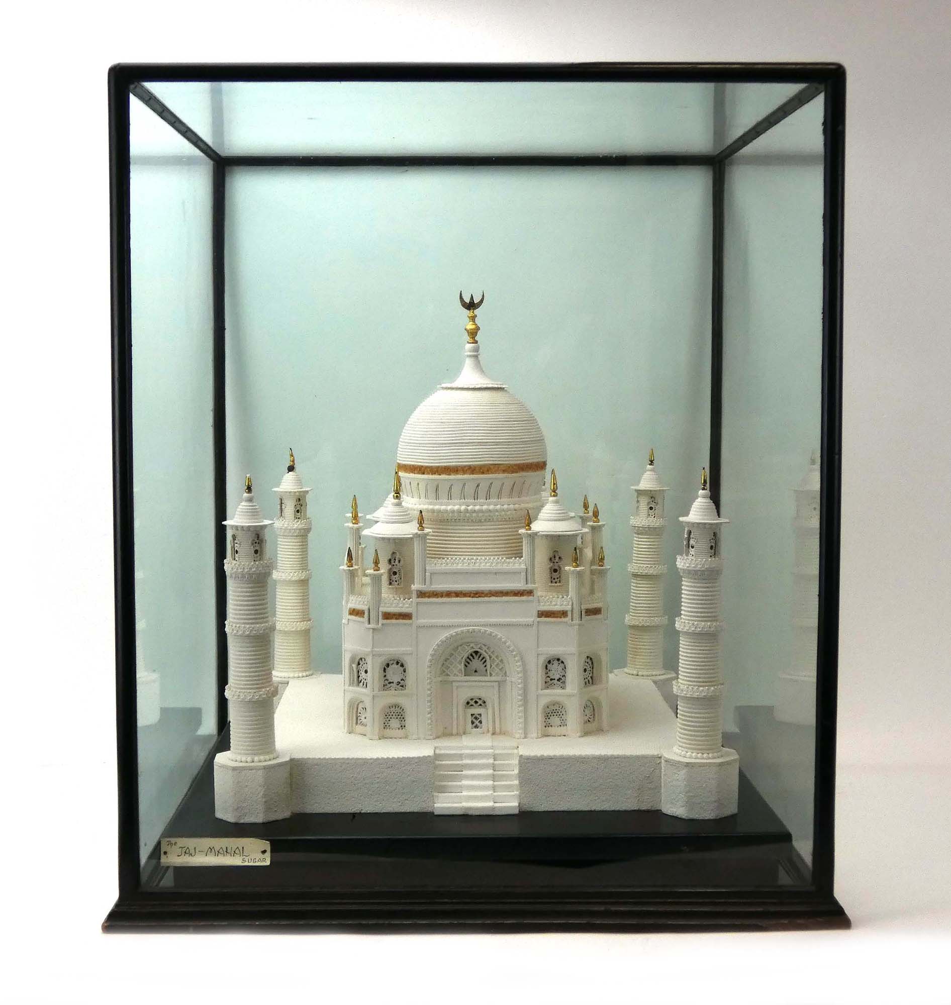 An ebonised and five-glass case containing a model of the Taj Mahal constructed from sugar with