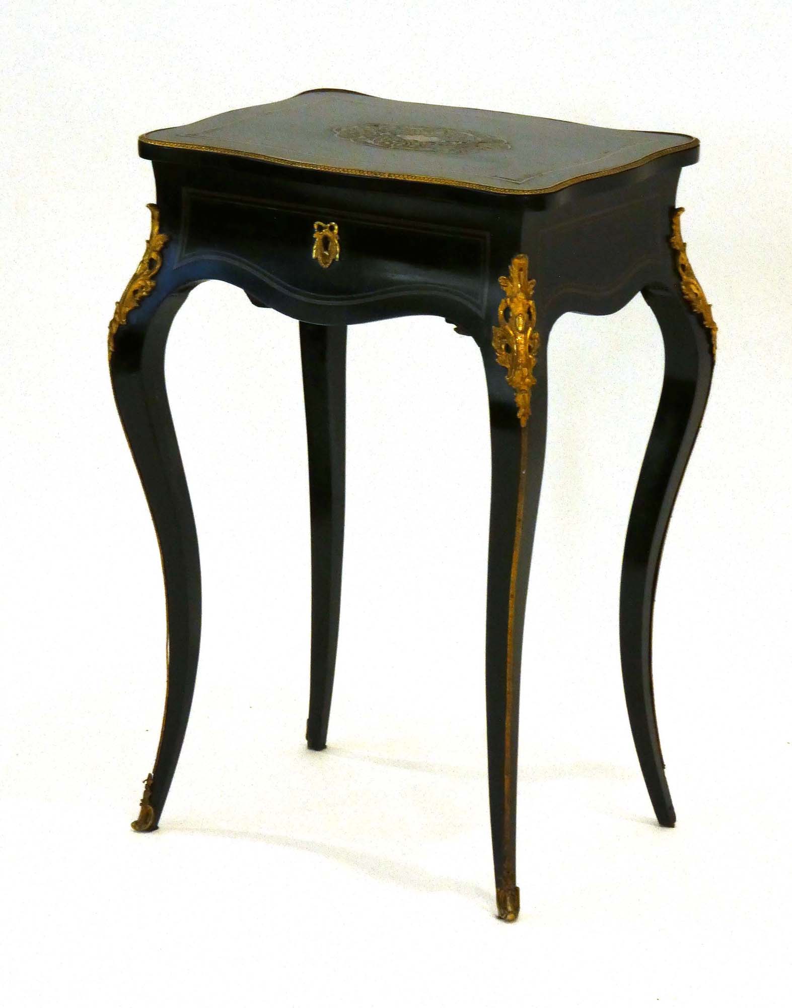 A 19th century ebonised and gilt metal mounted sewing cabinet on cabriole legs, w.
