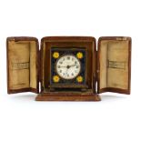 A cased Zenith Watch Co. miniature mantel timepiece in a champleve enamelled case with bun feet, h.