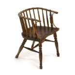 An 18th century spindle back armchair with a shaped elm seat
