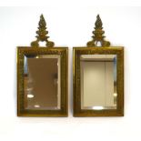 A pair of Victorian brass bevelled mirrors, each surmounted by a flame pediment,