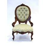 A Victorian mahogany and button upholstered nursing chair on turned front legs with castors