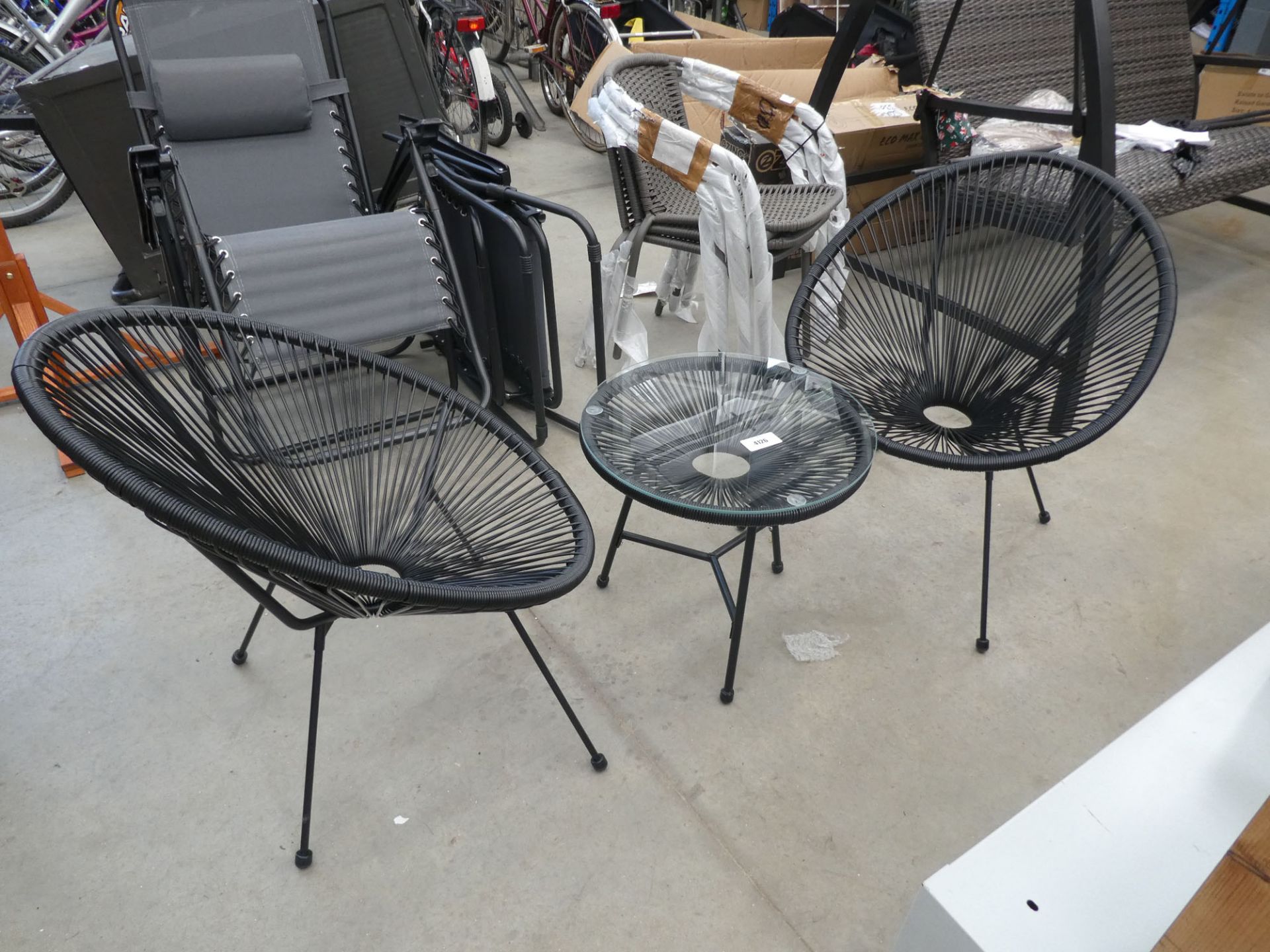 2 mesh style tub chairs and small glass topped coffee table