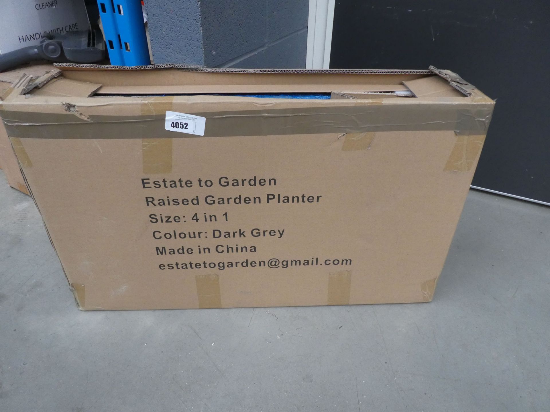 Box containing a metal flatpack garden planter