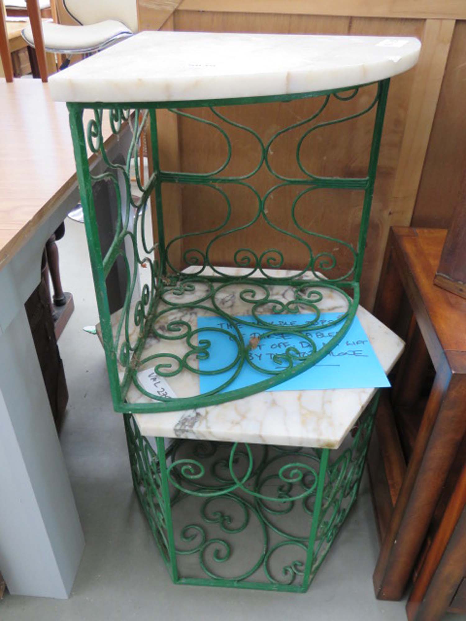 Corner wrought iron table with marble top together with one similar