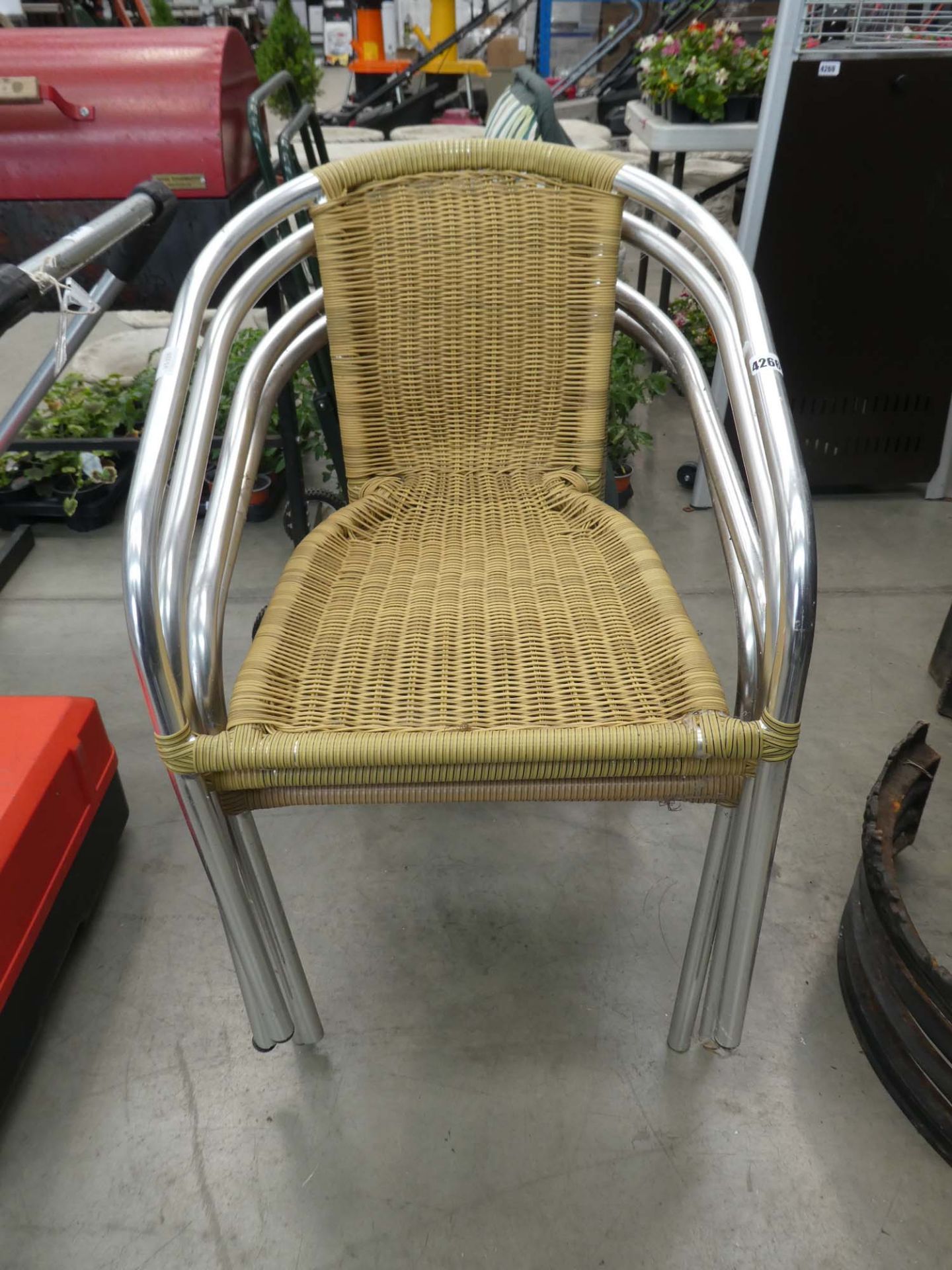 Four rattan style stacking chairs