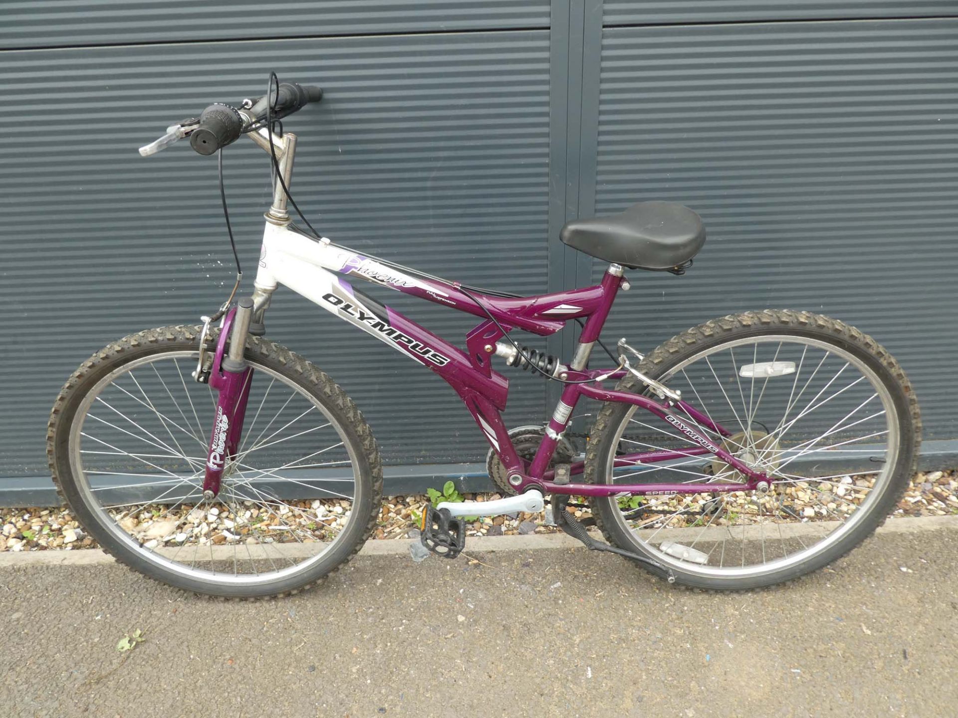 Purple and white Olympus suspension bike