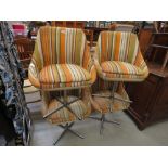 Four cream leather effect and striped fabric swivel chairs (collectors item, see soft furnishings