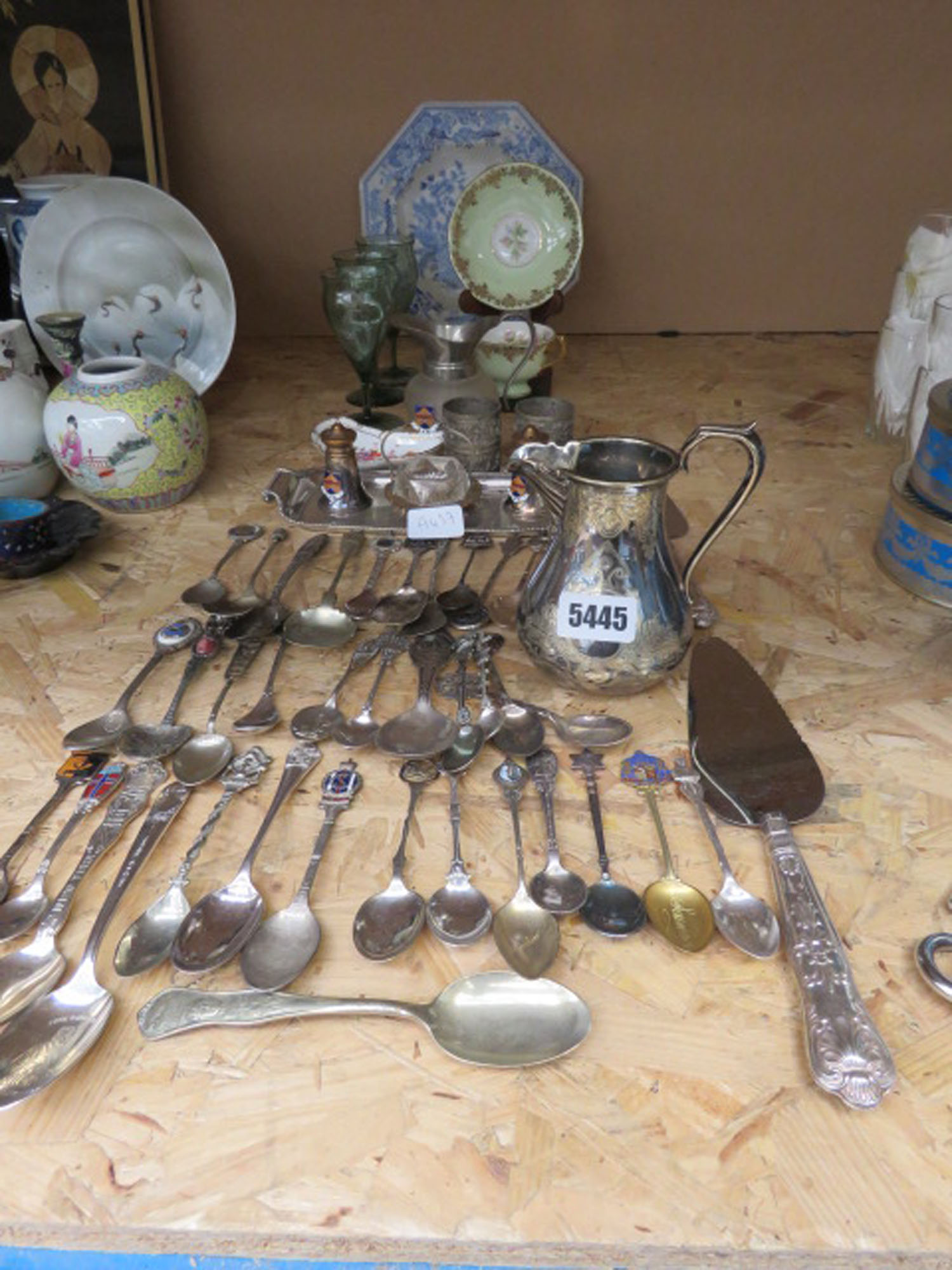 Quantity of souvenir spoons, napkin rings, silver plated milk jug, salt and pepper set, glassware