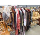 Chromed hanging rail with a quantity of vintage clothing and fur coats