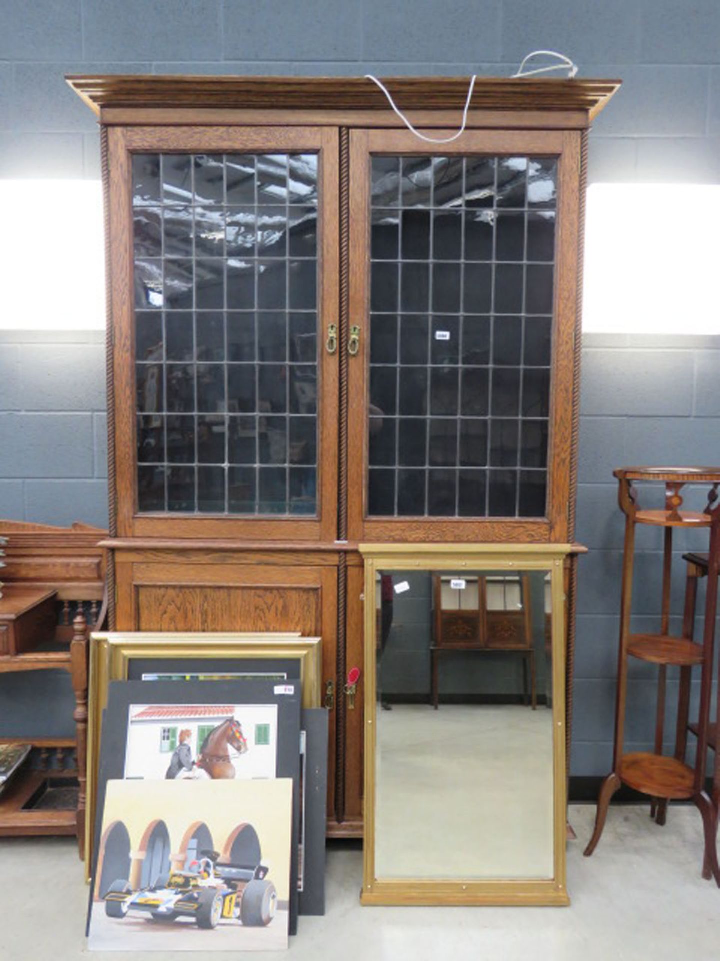 oak double door bookcase with cupboard base with glazed and leaded panels