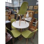 Circular white painted table plus 4 green moulded plastic chairs