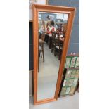 narrow rectangular mirror in pine frame