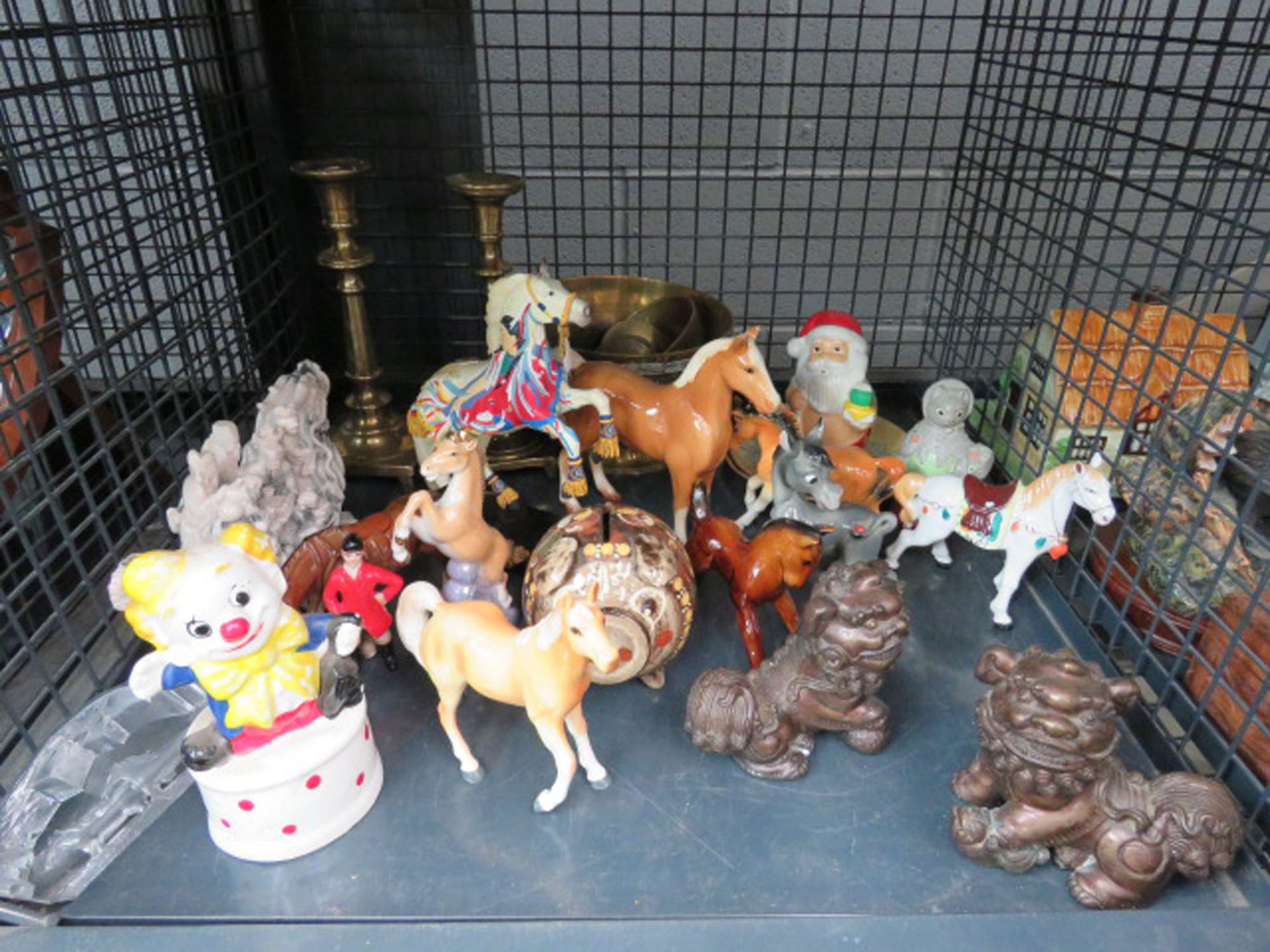 Cage containing brass candlesticks, pots and ornamental horse figures