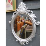 Oval mirror in silver painted frame