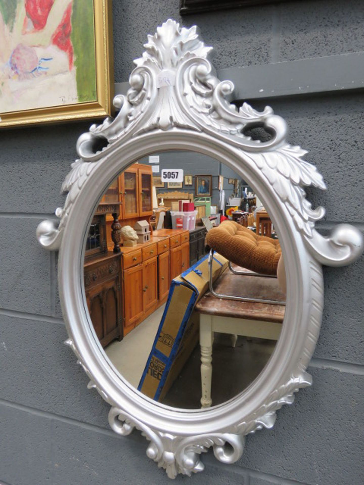 Oval mirror in silver painted frame