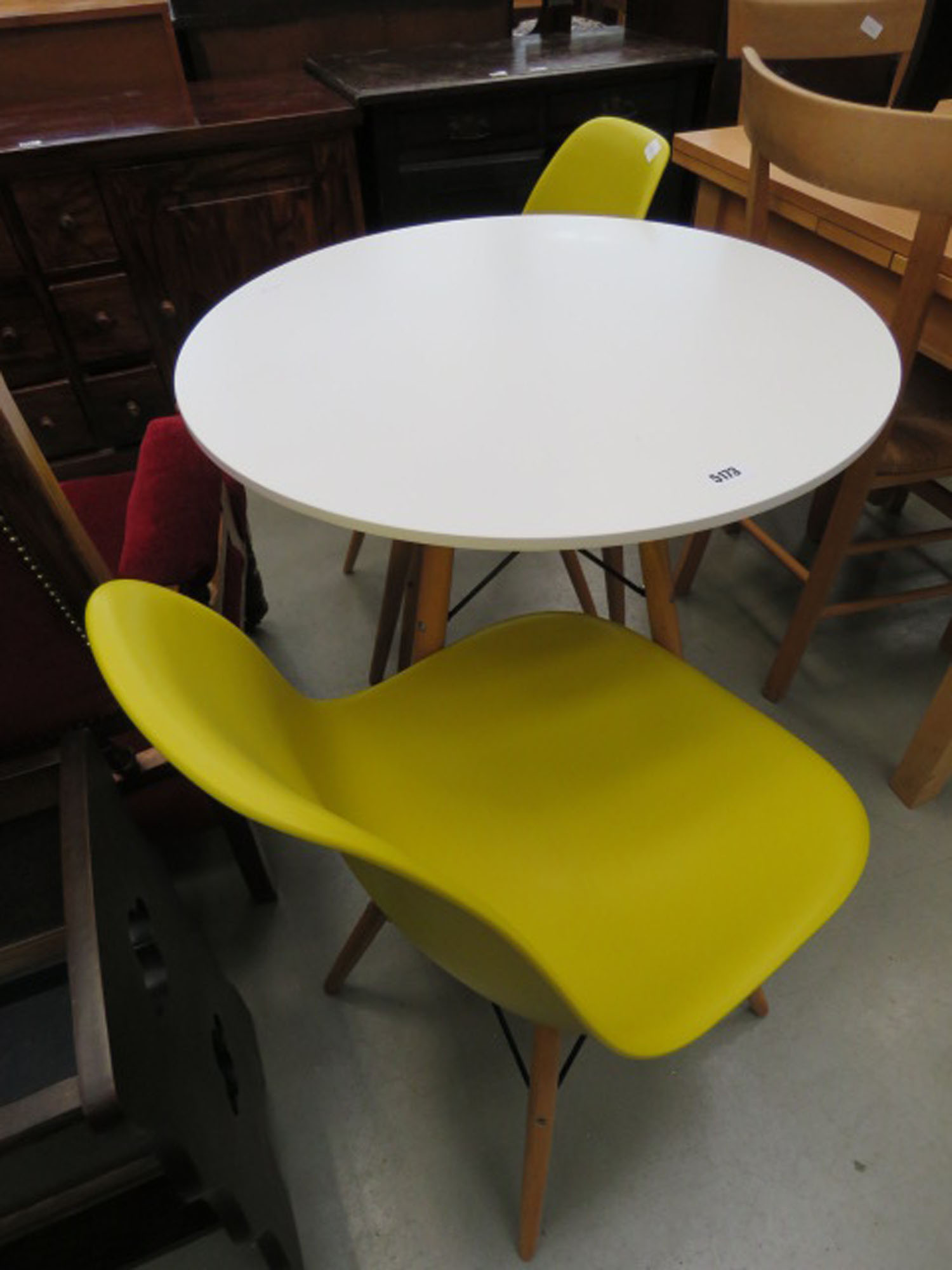 Circular white painted balcony table with 2 moulded plastic chairs