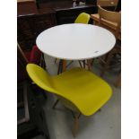 Circular white painted balcony table with 2 moulded plastic chairs