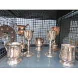 Cage containing silver plated goblets and trophies