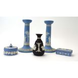 RR 411 - A pair of Wedgwood jasperware candlesticks typically decorated in the Neo-Classical manner,