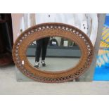 Oval mirror in rattan frame