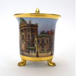 RR 415 - A Vienna porcelain cup with gilt scrolled handle and decorated with a view of