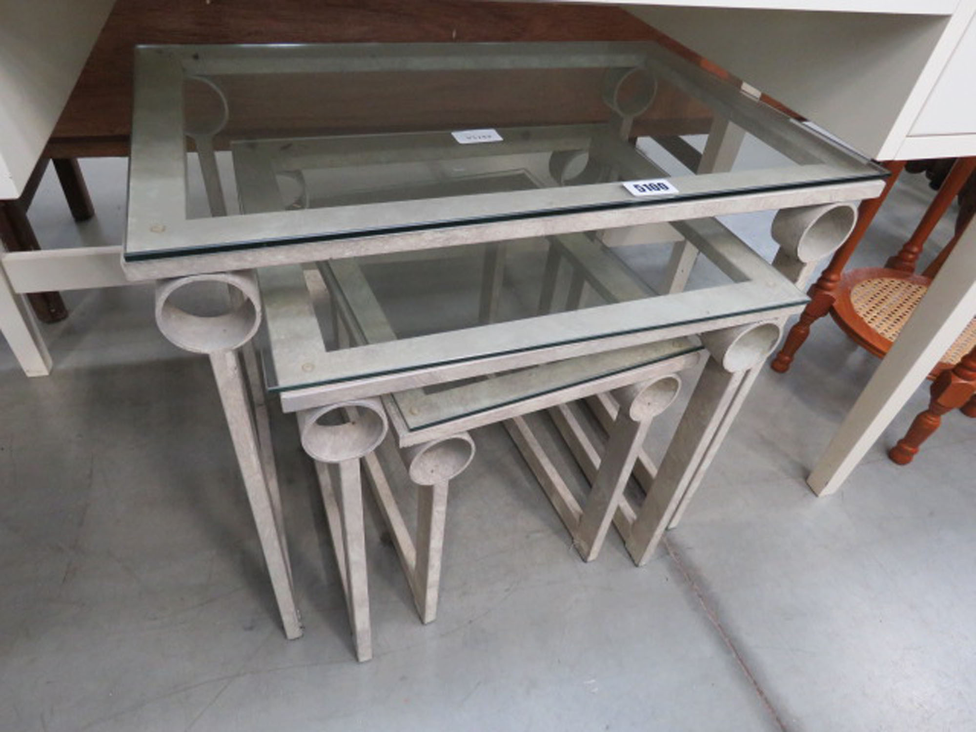 Painted wrought iron and glazed nest of 2 tables