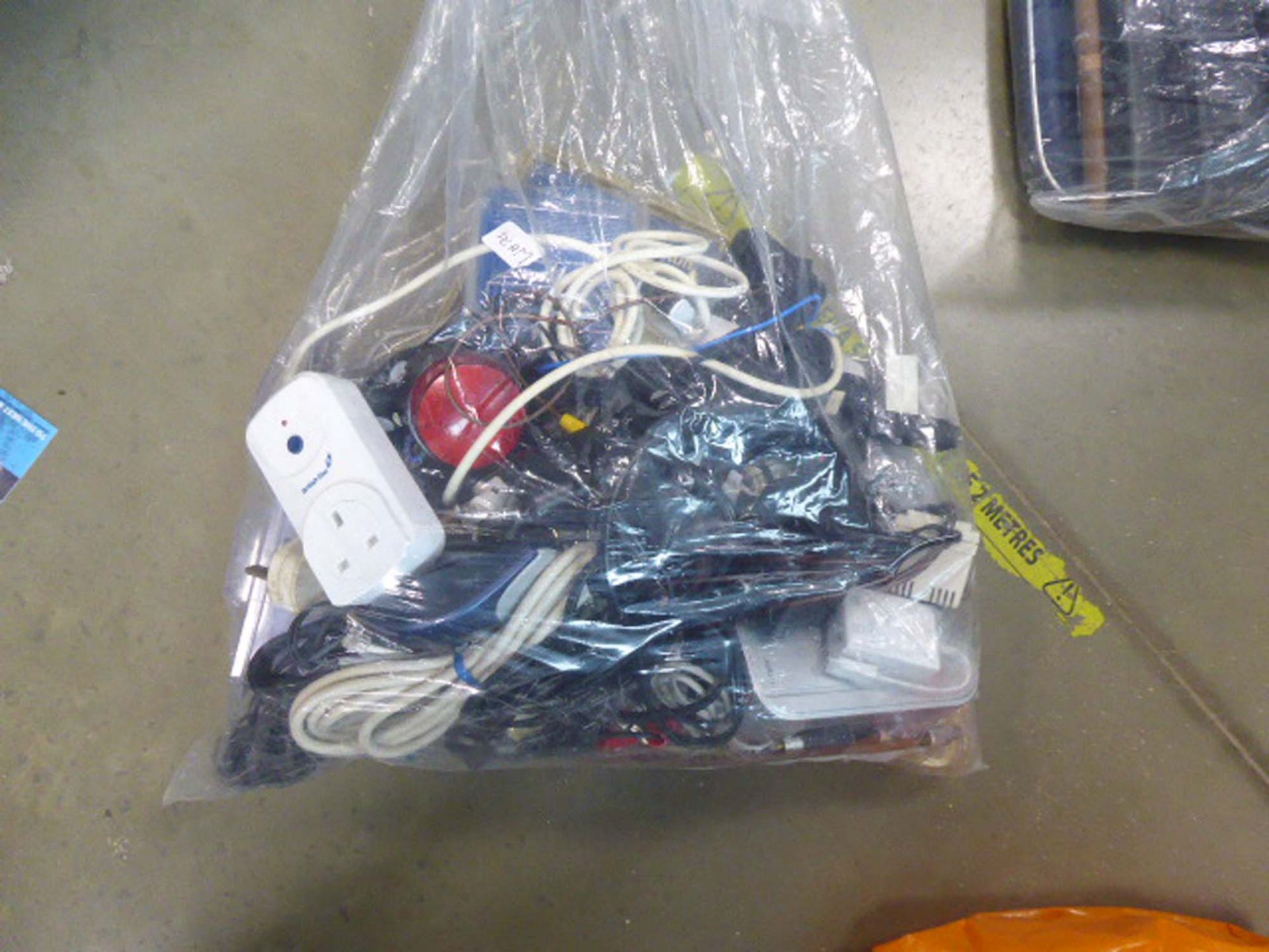 2574 Bag of various electrical sundries, oversize remote control, power adaptors etc