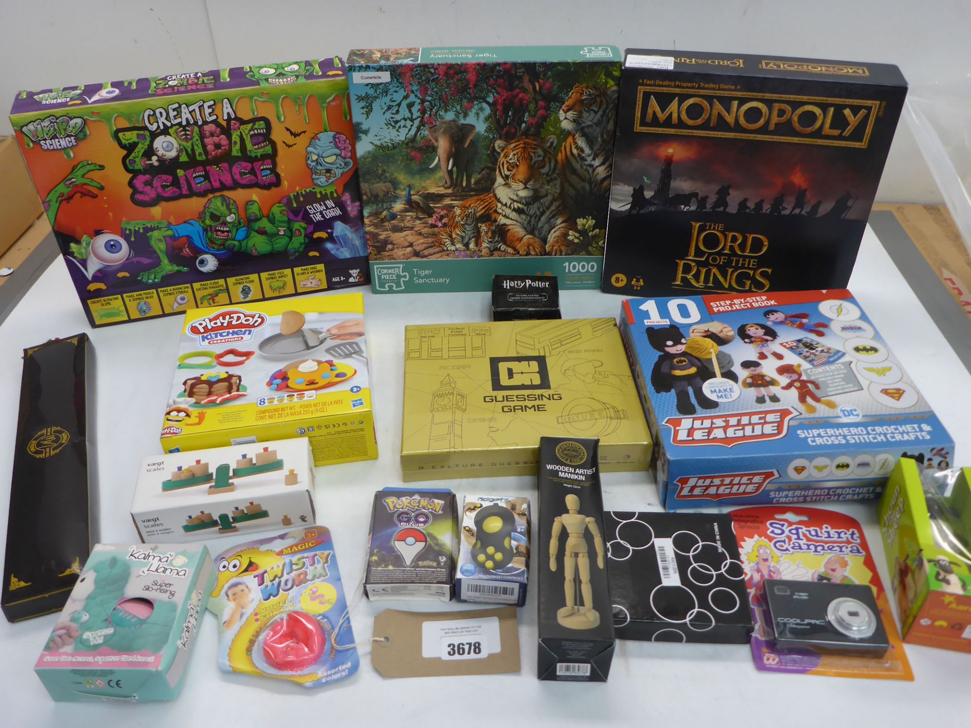 3678 Selection of games including Lord of the Rings Monopoly, Zombie Science, Play-Doh, Guessing