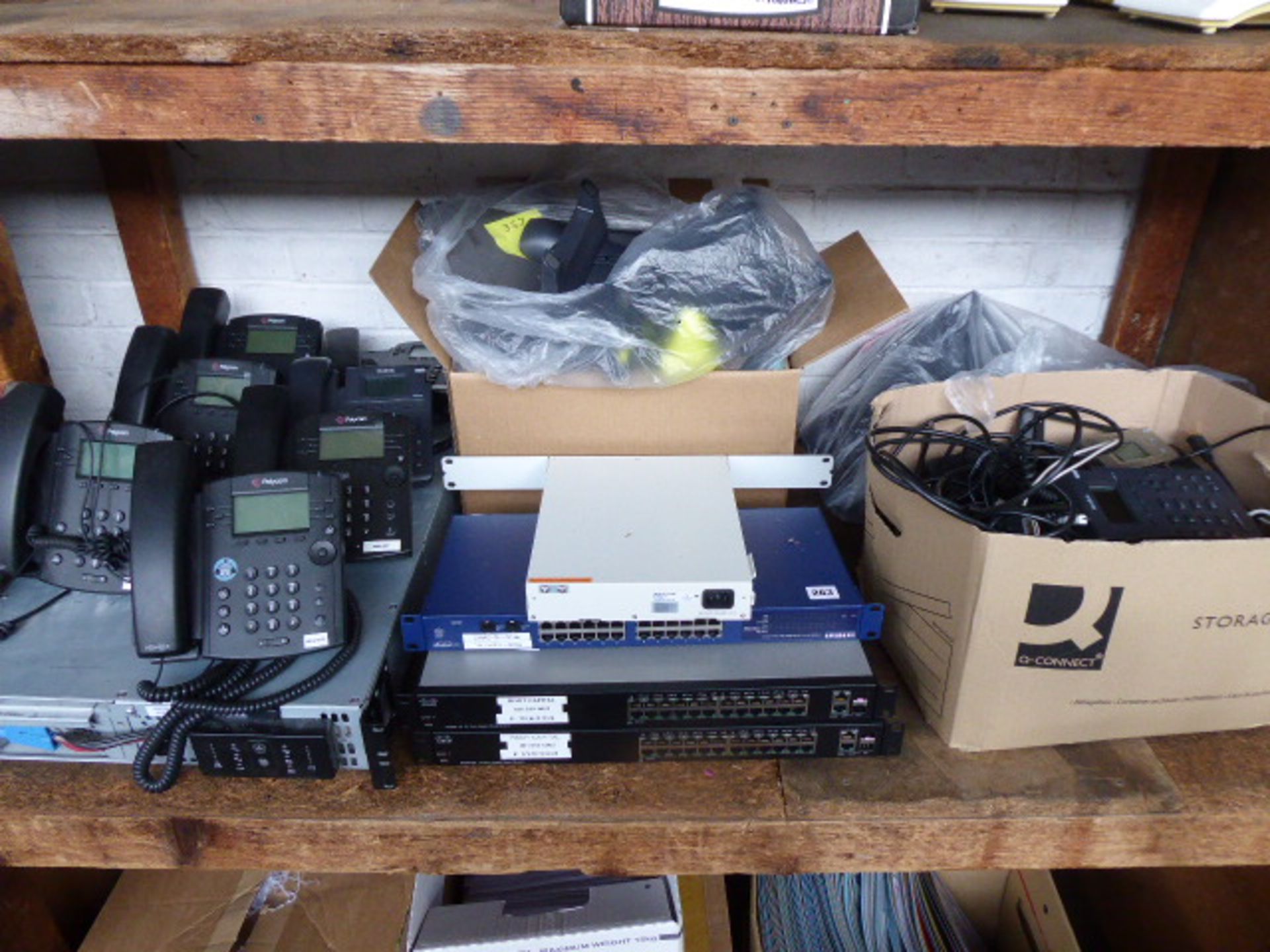 Shelf of Telecoms equipment and IT including 8 Yealink and Polycom desk phones,a UPS 2 Cisco