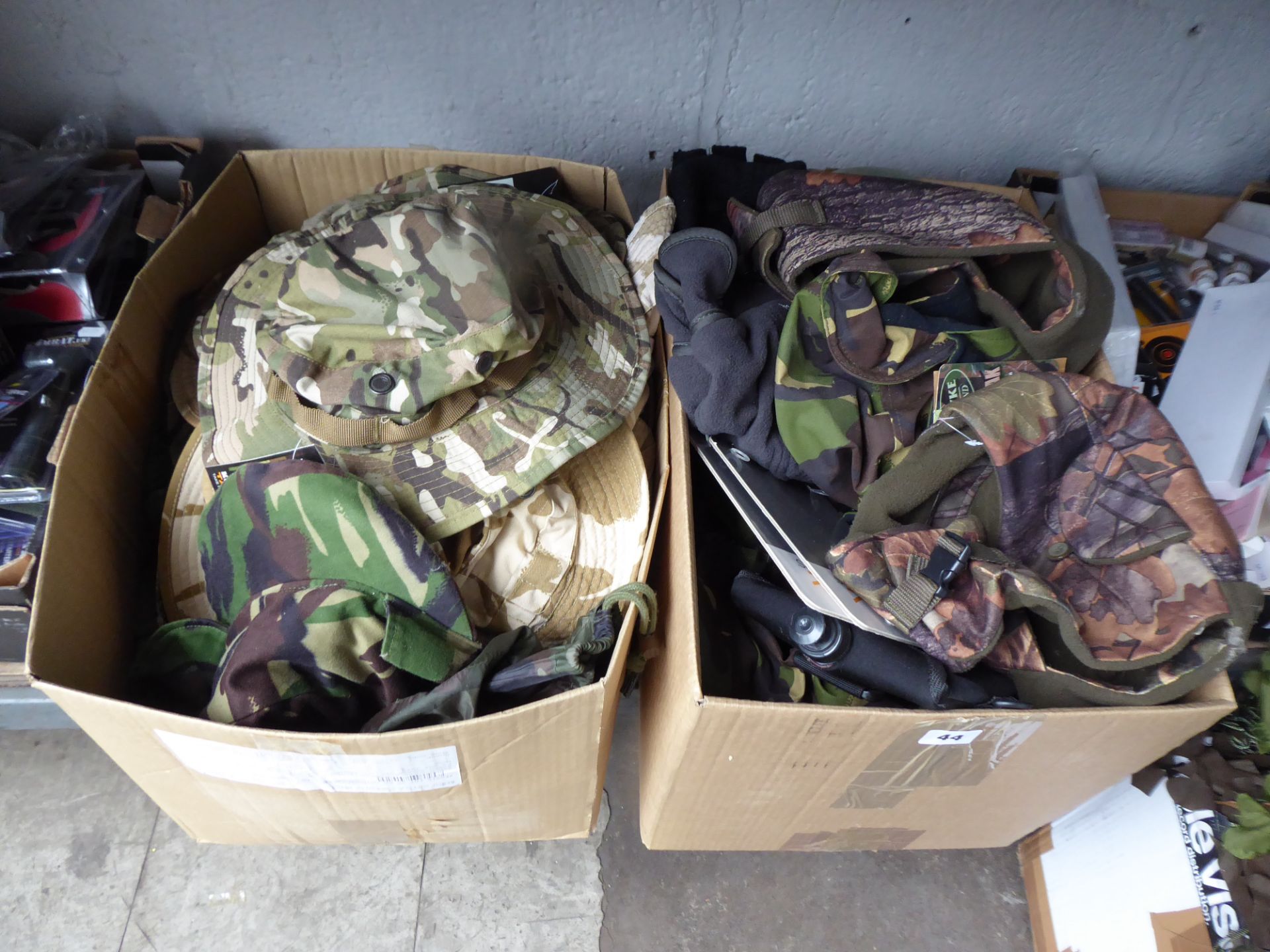 Twop boxes of camo hats etc.