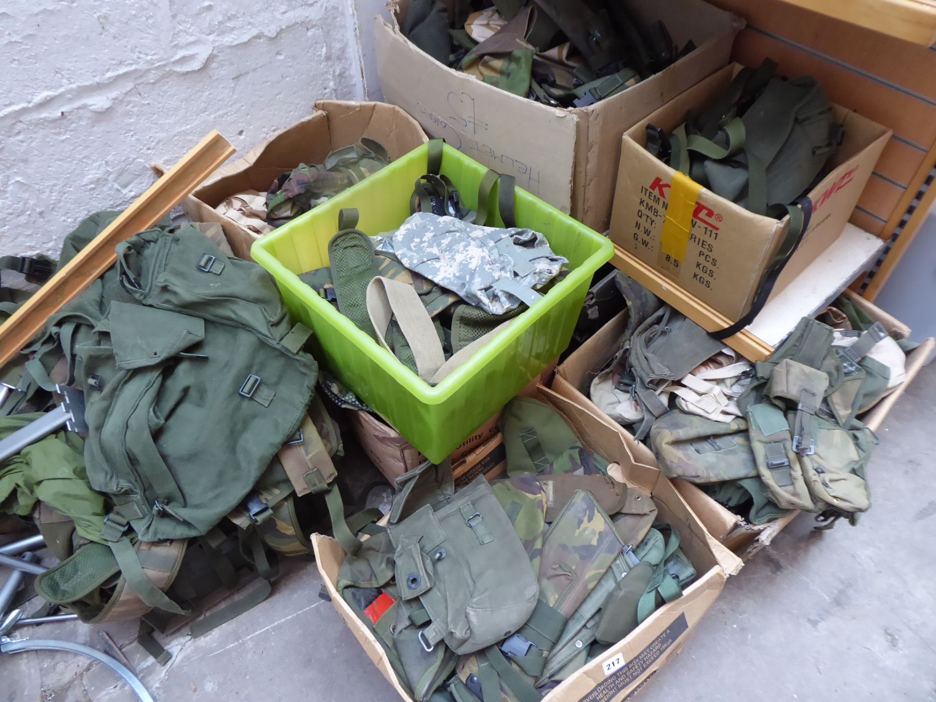 Eight boxes of forest green pouches, hoods, webbing etc.