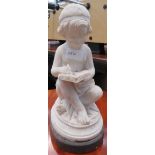 Alabaster figure of a child reading