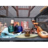 Cage containing Guiness glasses and mug, coloured glass, reference books, tape cassettes, and