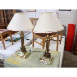 Pair of brass fluted table lamps with conical cream shades