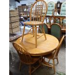 Single pedestal circular dining table and 4 matching spindle back chairs