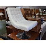 Cream leatherette upholstered swivel easy chair on chrome circular base