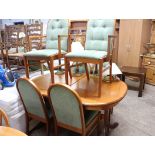 Mid century extending dining table with 6 (2+4) green upholstered chairs