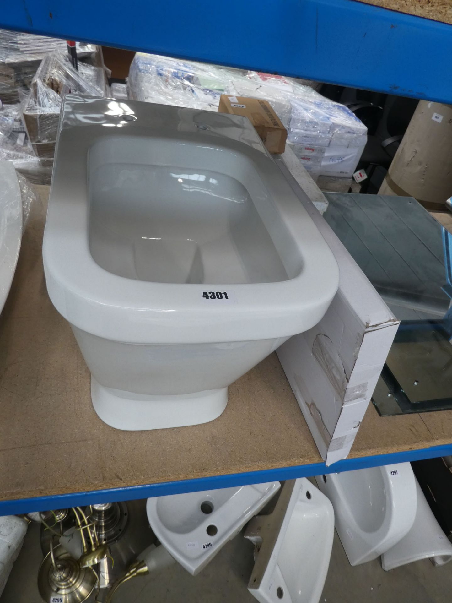 White back to wall toilet with boxed seat