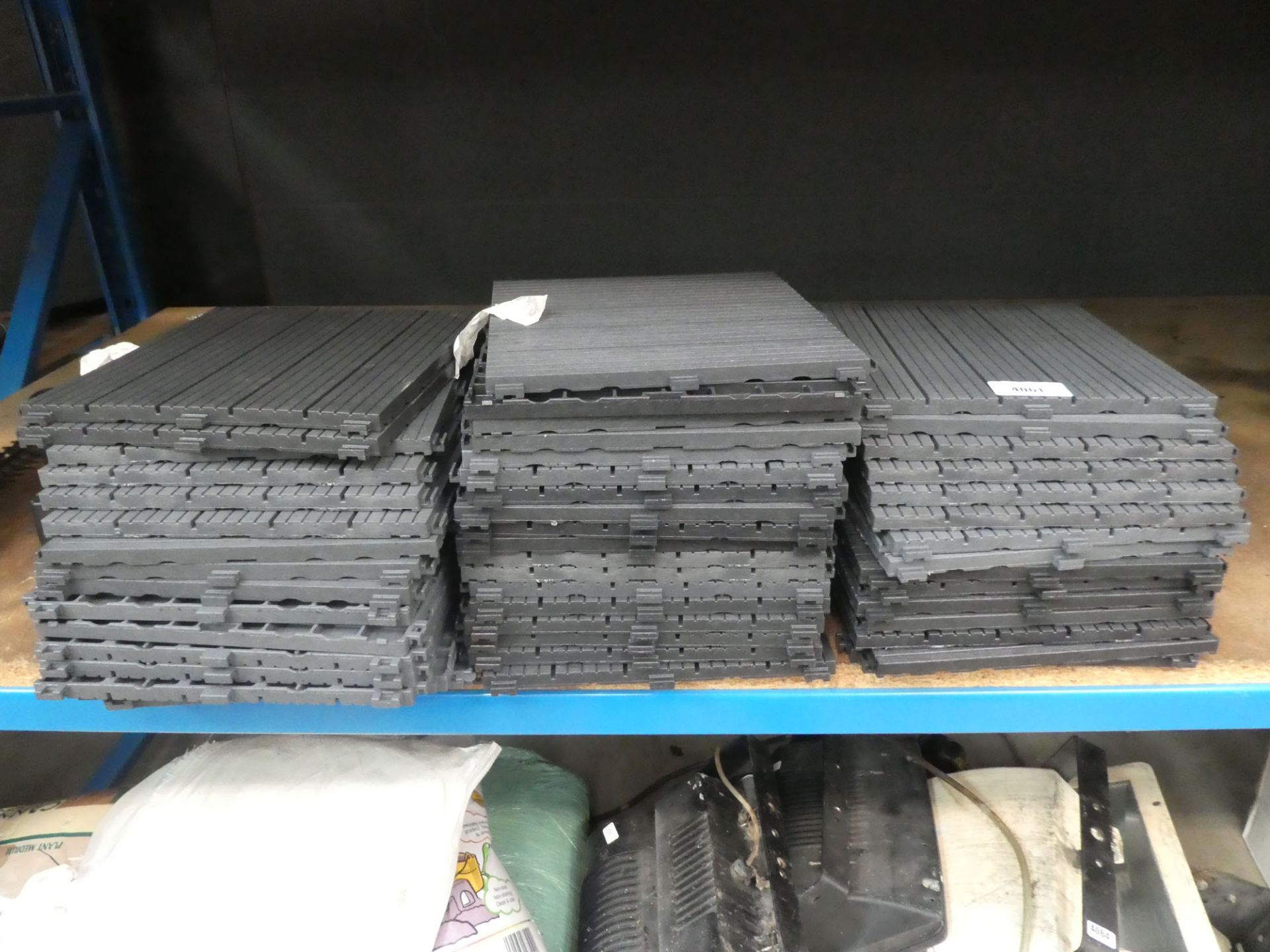 3 stacks of clip together plastic flooring