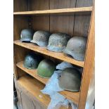 Seven military helmets