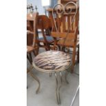 Metal chair with tiger print seat