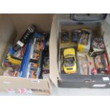 2 boxes containing diecast cars and buses