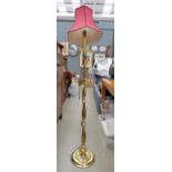 Brass finished floor lamp with red fabric shade