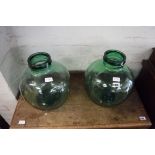 2 green glass carboys