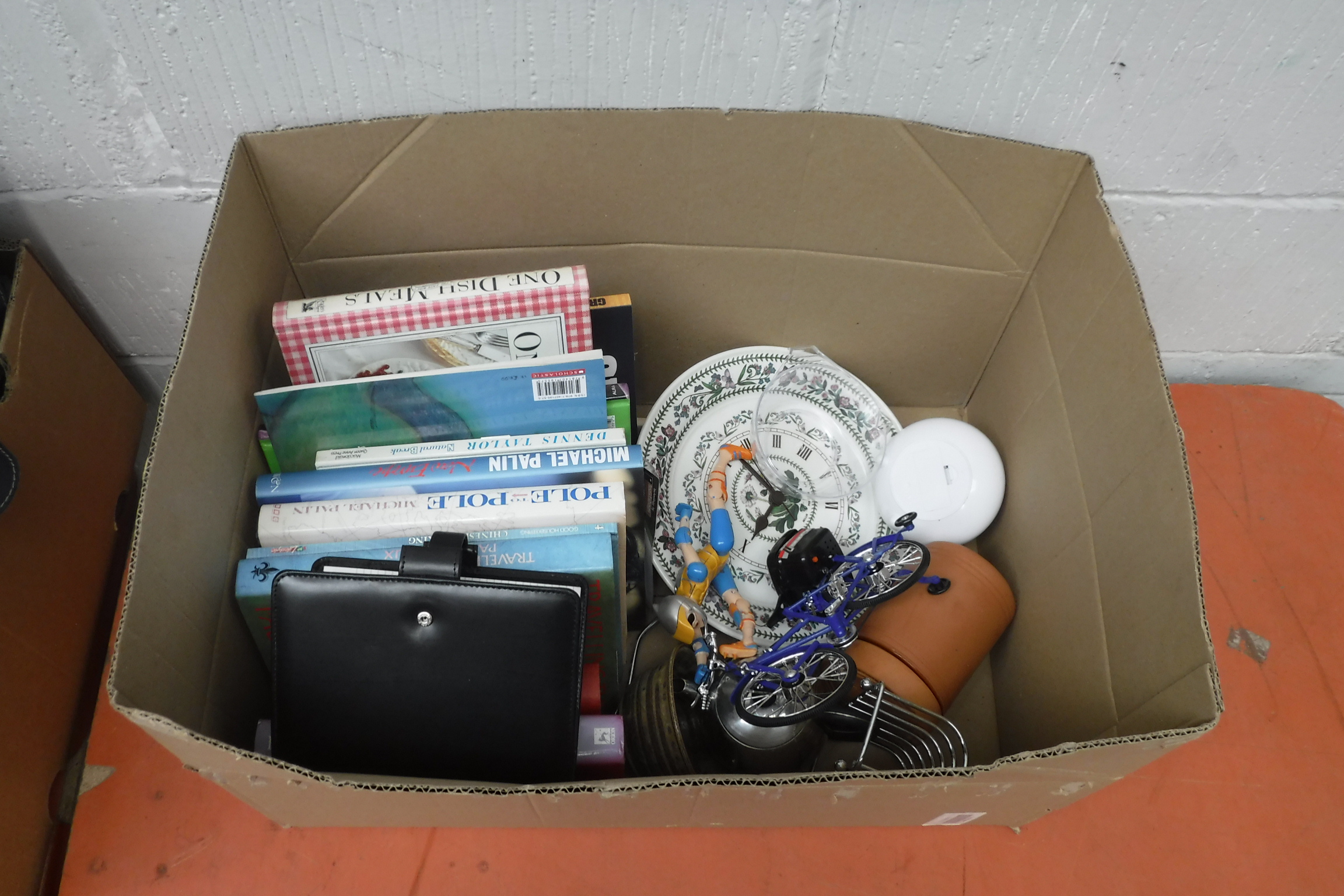 (2319) Crate containing ceramic clock, cyclist ornament, storage jar, diary and books